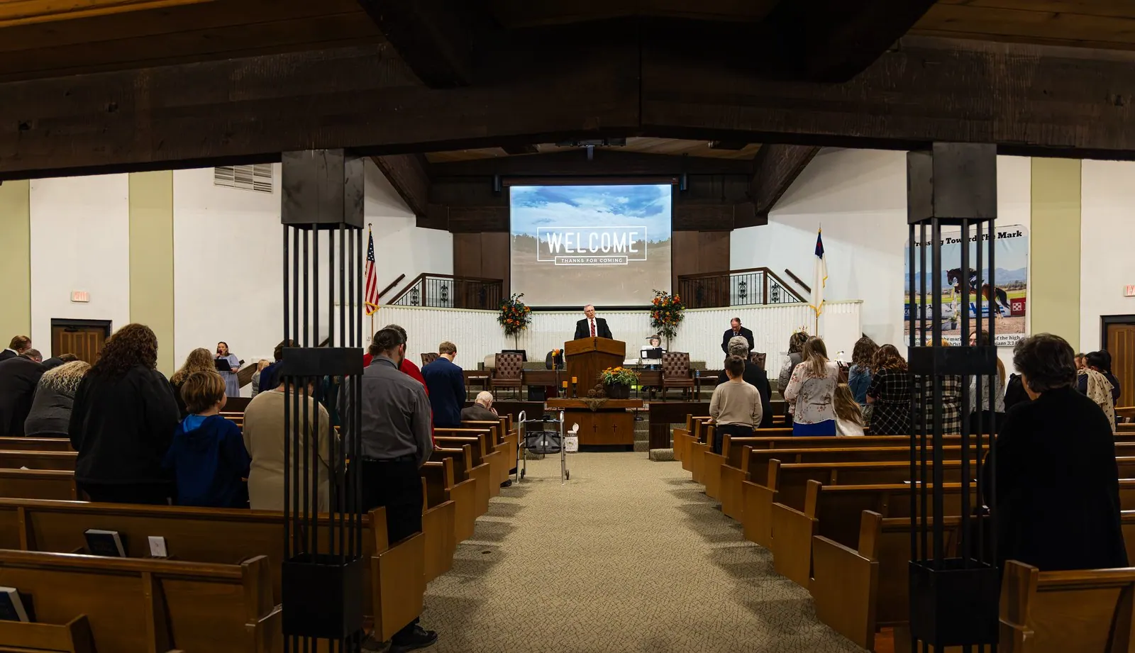 The congregation standing together during a Sunday service in the Averyville Baptist Church sanctuary.