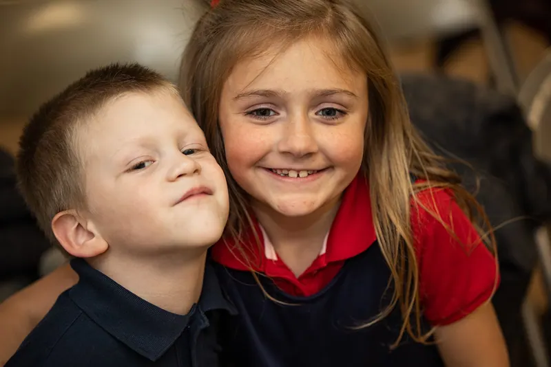A young boy and girl side by side at church.
